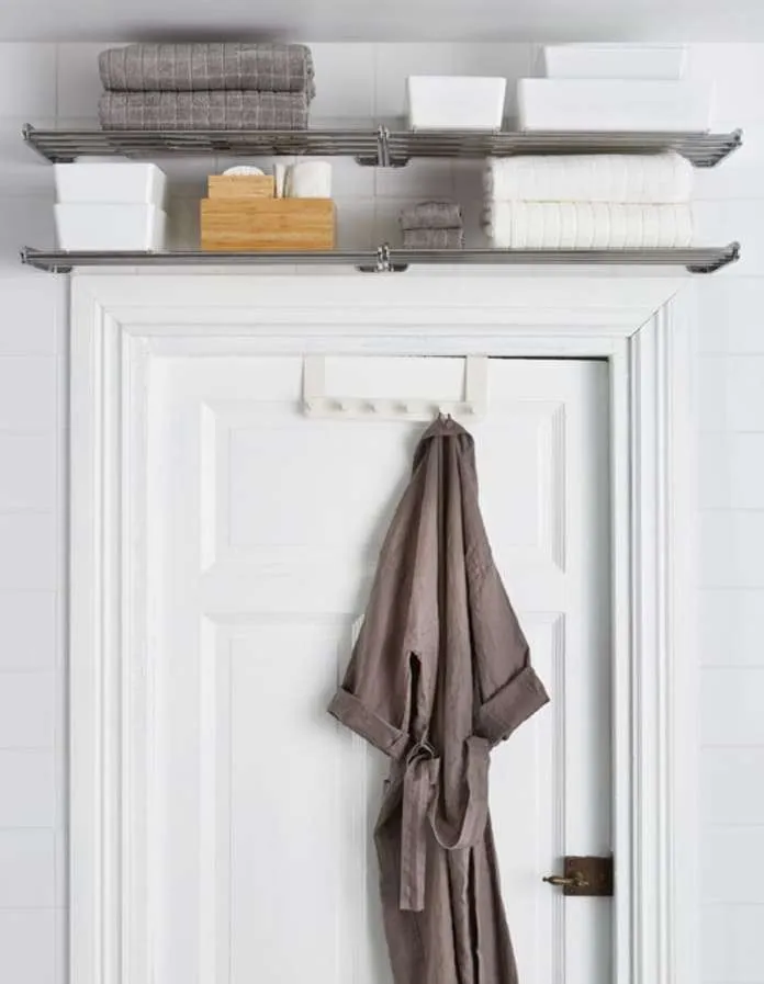 storage shelf above bathroom door in small apartment
