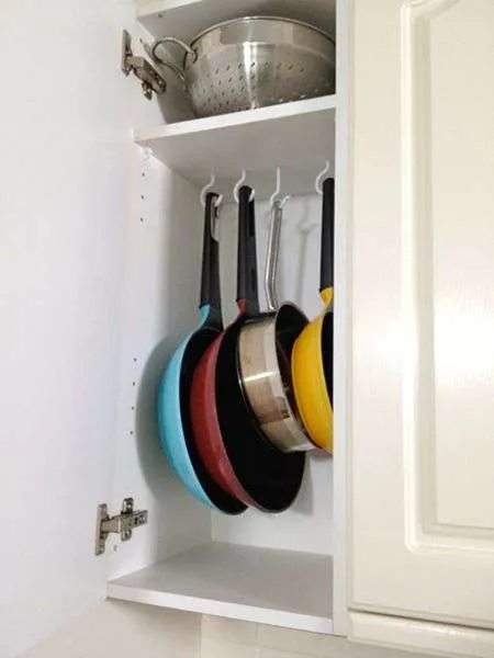 hooks inside kitchen cabinet for storing pans