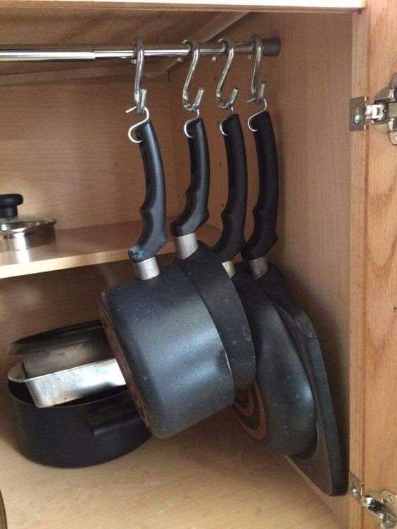 hanging pot rack in cabinet with tension rod