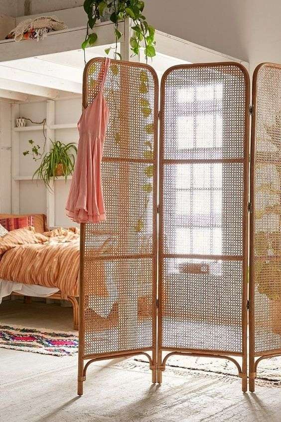 create a bedroom in a studio with a room divider